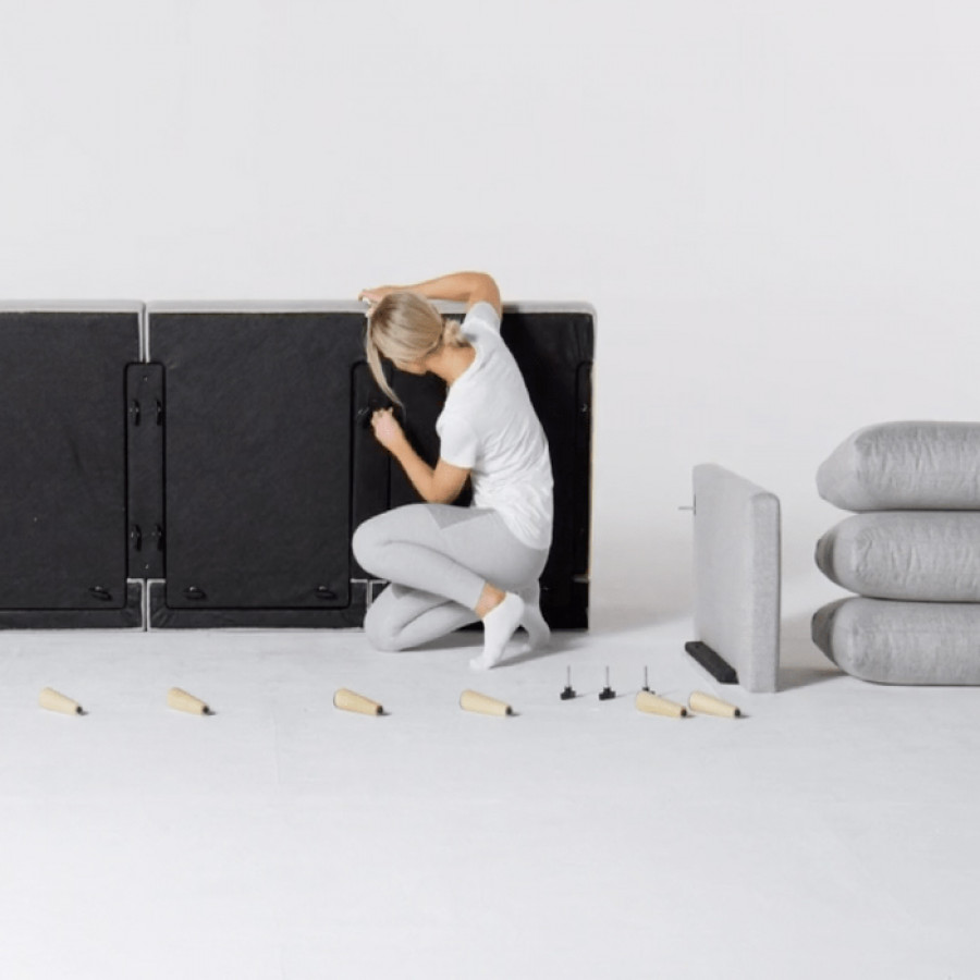 Woman assembling light gray Allform Sofa